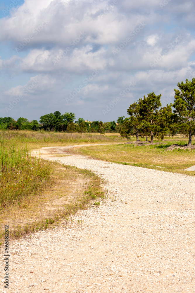 Twisty gravel road in the countryside on a cloudy summer day. Twisty gravel road in the countryside on a cloudy summer day.
