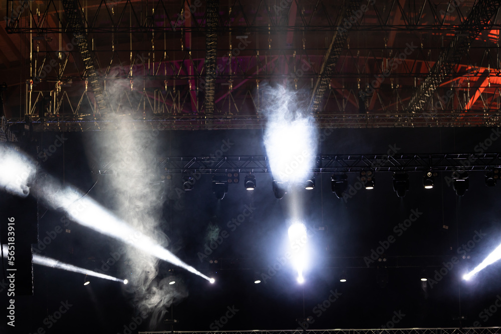 Spotlights illuminate the stage with a strong white light