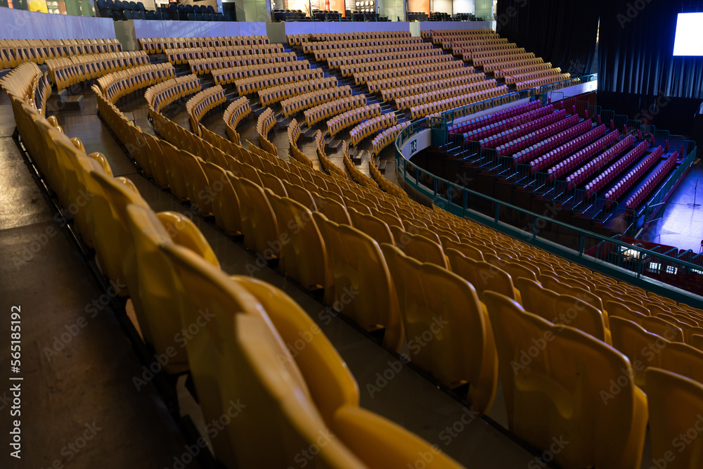 Fototapeta premium Yellow and red seats surround the stage