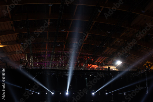 Illuminating spotlights illuminate the hall from the stage