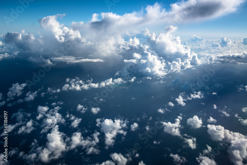 Photography Aerial view above the clouds and French Polynesia, atoll