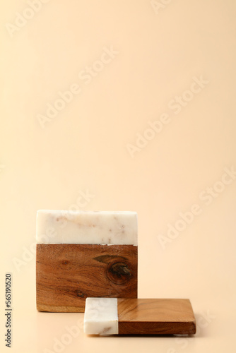 Fototapeta Naklejka Na Ścianę i Meble -  Stands for cosmetic products display on pastel beige background. Empty wooden and marble platforms, beauty products presentation concept.