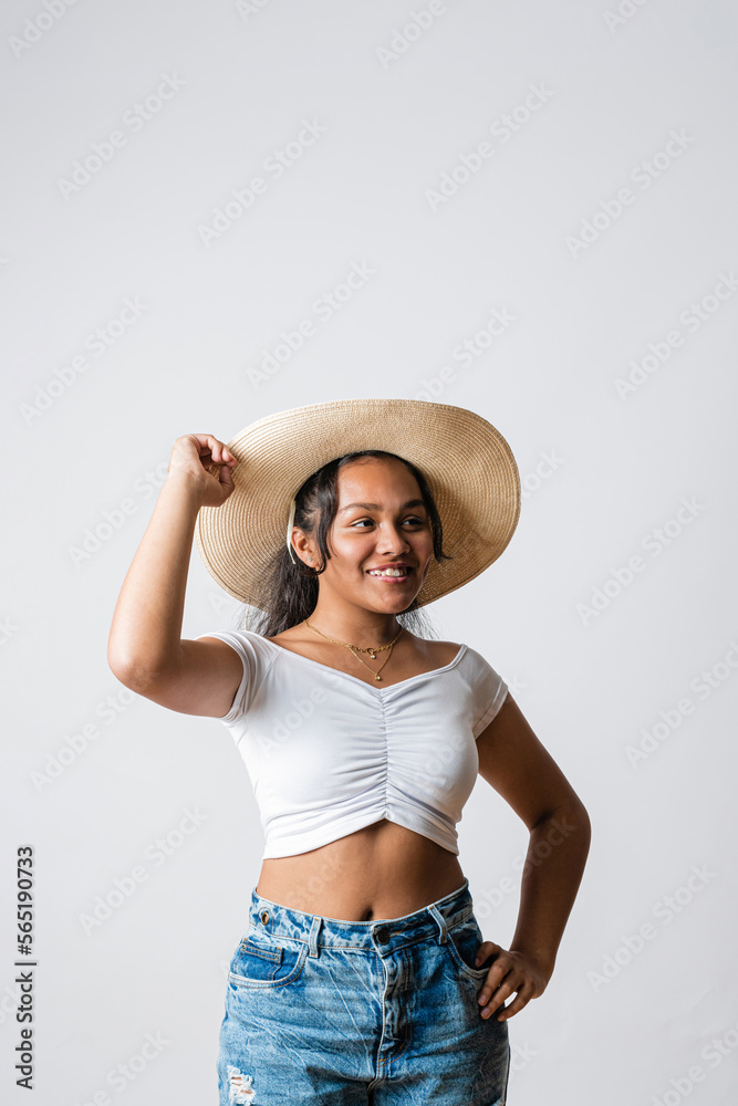 Happy latin american girl wearing a hat. Travel teenager visiting places and sightseeing. Smiling young brunette woman wearing blouse, jeans and hat. travel concept Happy latin american girl wearing a hat. Travel teenager visiting places and sightseeing. Smiling young brunette woman wearing blouse, jeans and hat. travel concept
