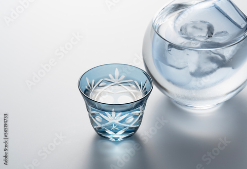 Sake poured into a faceted glass on a white background.