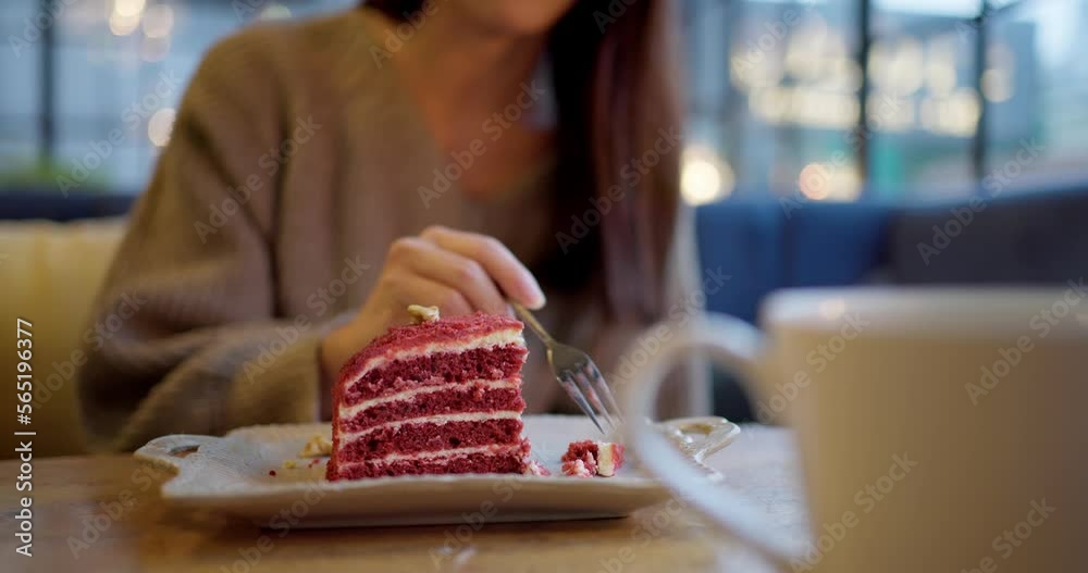 Woman eat slice of red velvet cake cake