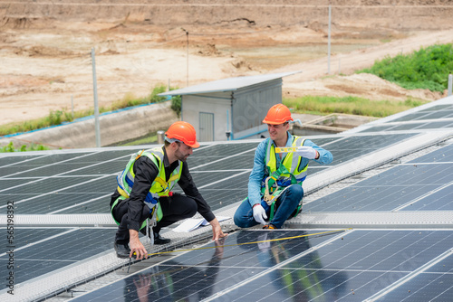 Wallpaper Mural technician engineer working on checking maintenance service with solar batteries near solar panels at sunny day in solar power plant station on rooftop, electricity energy of photovoltaic industrial Torontodigital.ca