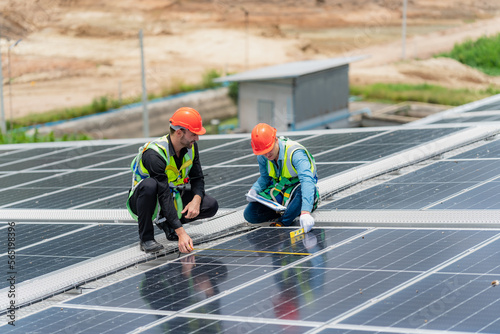 Wallpaper Mural technician engineer working on checking maintenance service with solar batteries near solar panels at sunny day in solar power plant station on rooftop, electricity energy of photovoltaic industrial Torontodigital.ca