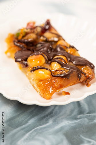 Golden baked florentine bar with mixed nuts, cranberries, and drizzled dark chocolate.