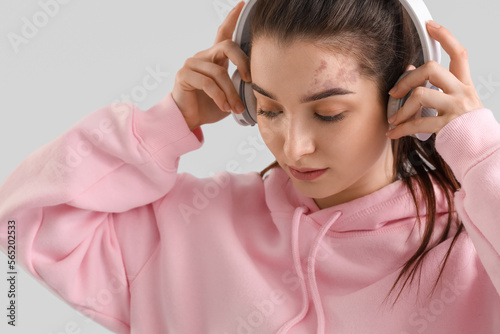 Young woman in headphones a...