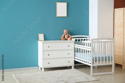 Stylish interior of children's room with baby bed