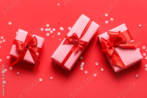 Gifts and sequins on red background. Valentine's Day celebration