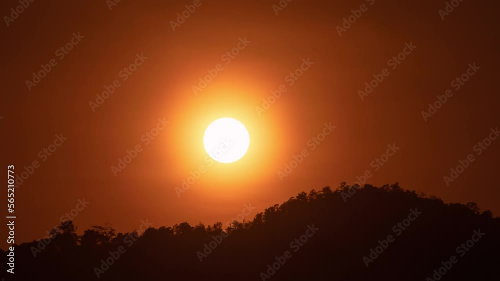 Timelapse of dramatic sunset with orange sky in a sunny day.