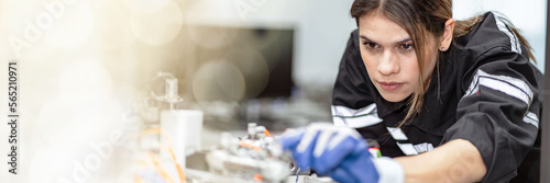 Banner Team woman of engineers practicing maintenance Taking care and practicing maintenance of old machines in the factory so that they can be used continuously.