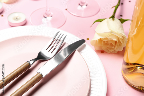 Table setting with white rose flower on pink background. Valentine's Day celebration