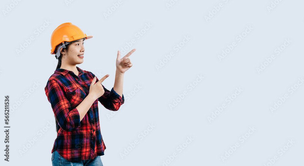 Young asian engineer female standing with point finger posture Young asian engineer female standing with point finger posture