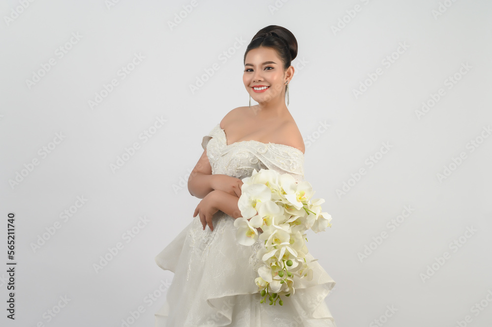 Young asian beautiful bride with orchid bouquet on white background Young asian beautiful bride with orchid bouquet on white background
