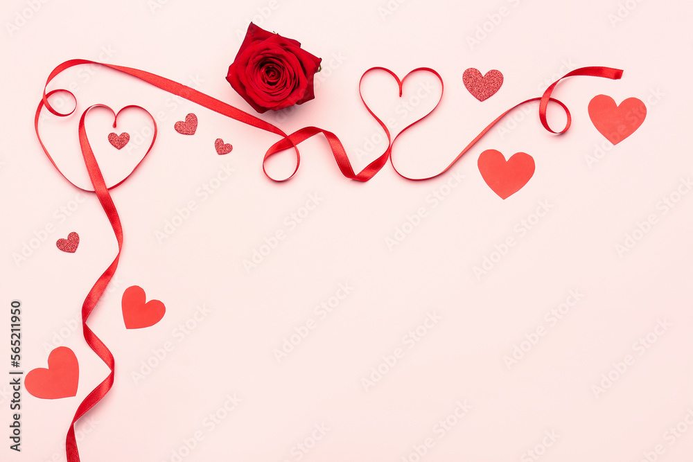 Rose flower and hearts made of red satin ribbon on pink background. Valentine's Day celebration