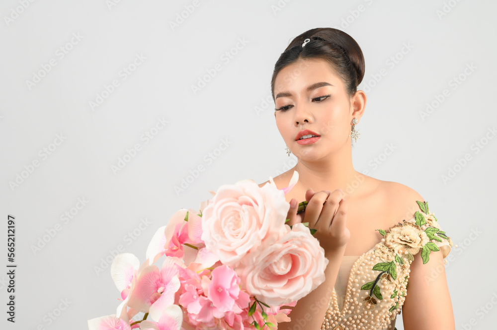 Young asian beautiful bride with orchid bouquet on white background Young asian beautiful bride with orchid bouquet on white background