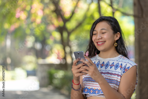 mexican woman indigenous traits using smart phone, business woman