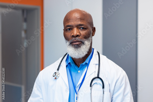 Portrait of serious african american senior male doctor in hospital corridor