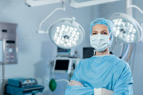 Portrait of caucasian female surgeon in an operating theatre, wearing face mask photo