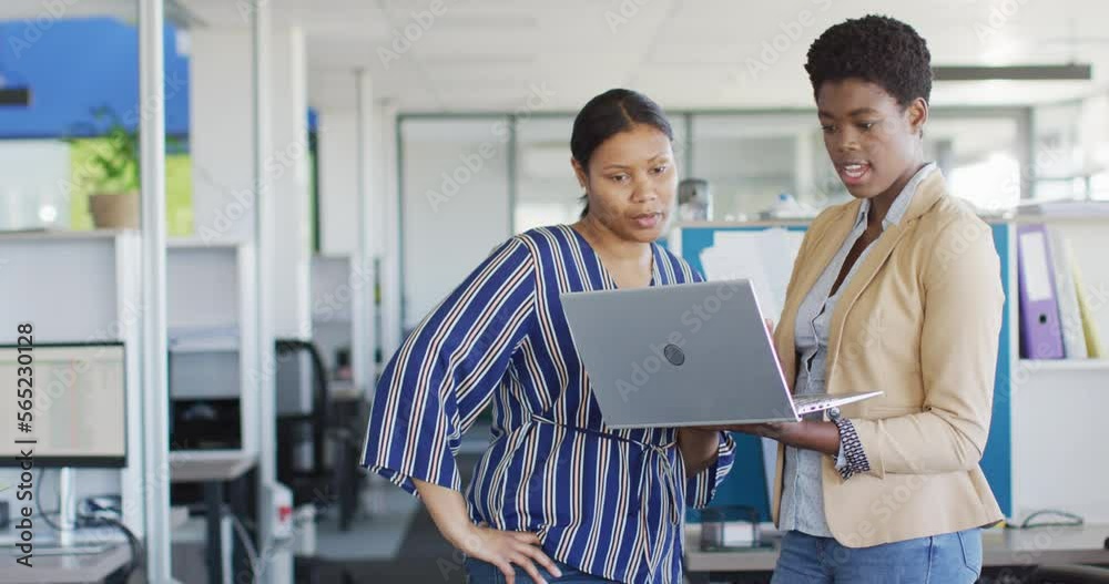 African american business people using laptop at office, slow motion