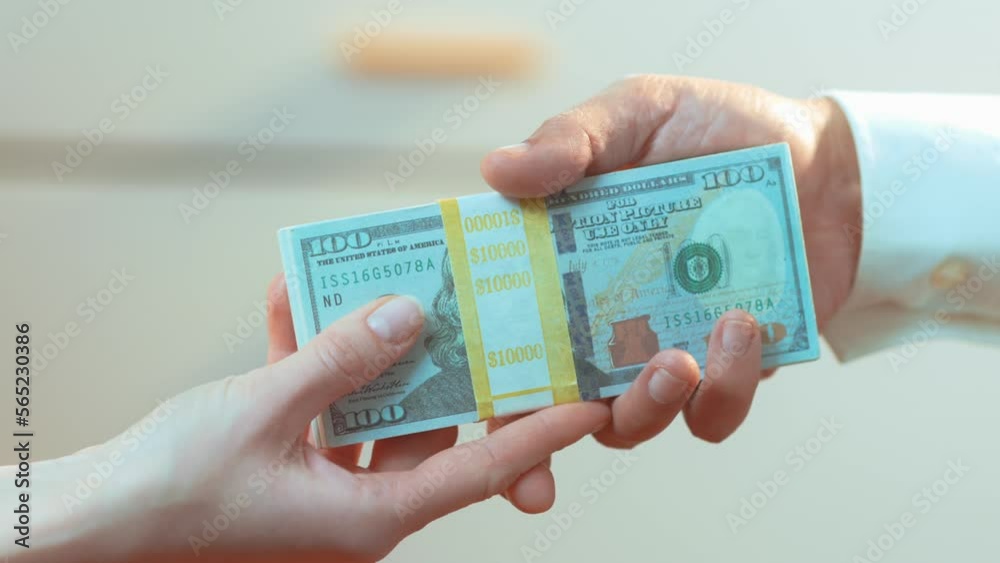 (Camera: ARRI ALEXA, 50mm lens) A caucasian woman handing a latino male a stack of cash. For more variations of this clip, check out this seller's other videos.