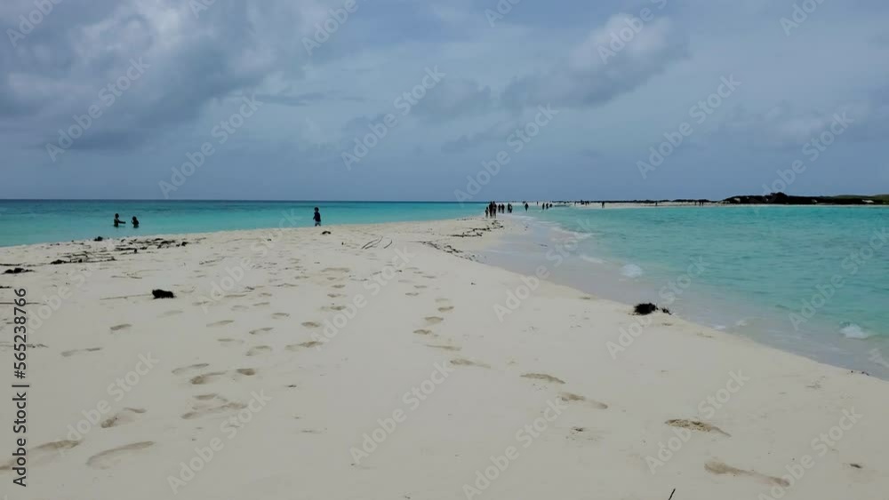 People walking barefoot leaving their footprint on white sandbank, Cayo de agua Los Roques People walking barefoot leaving their footprint on white sandbank, Cayo de agua Los Roques