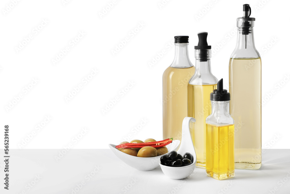Bottles of different cooking oils and olives on white background Bottles of different cooking oils and olives on white background