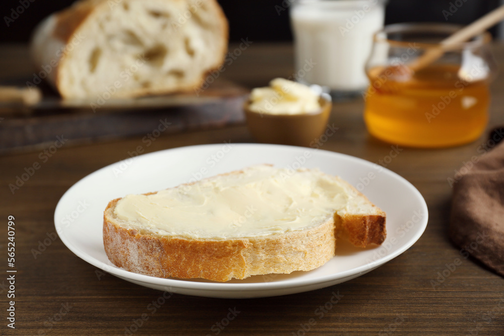 Sandwich with butter near honey on wooden table, closeup Sandwich with butter near honey on wooden table, closeup