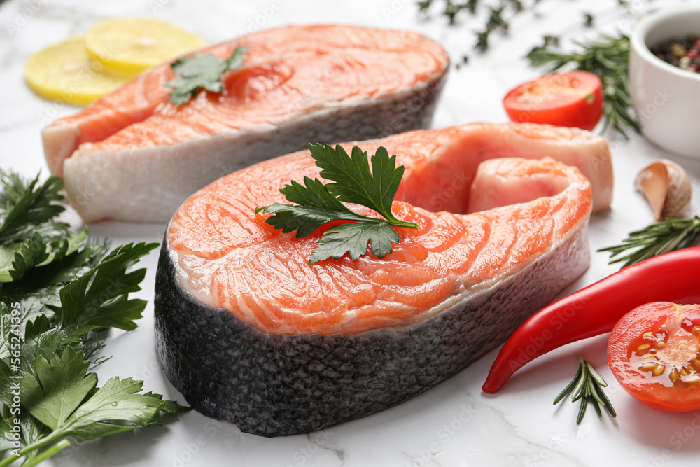 Fresh salmon and ingredients for marinade on white marble table, closeup Fresh salmon and ingredients for marinade on white marble table, closeup