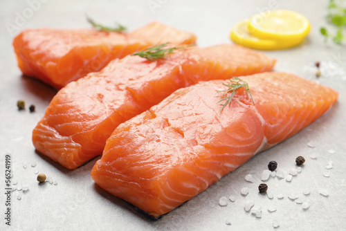 Fresh raw salmon and ingredients for marinade on light grey table, closeup