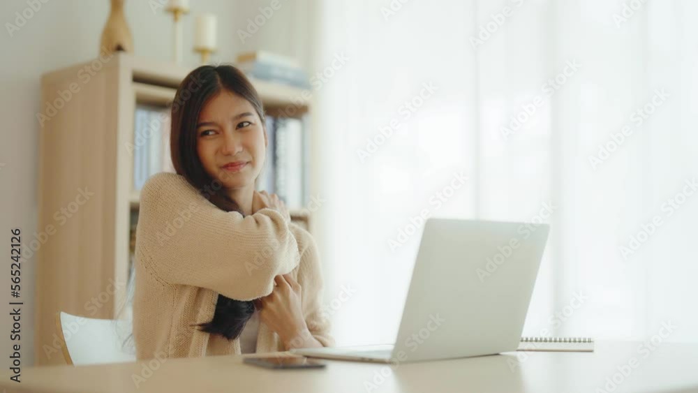 Office syndrome concept. Young asian woman feeling pain in neck and shoulder after working on computer laptop for a long time. She stretches to relax her muscles Office syndrome concept. Young asian woman feeling pain in neck and shoulder after working on computer laptop for a long time. She stretches to relax her muscles