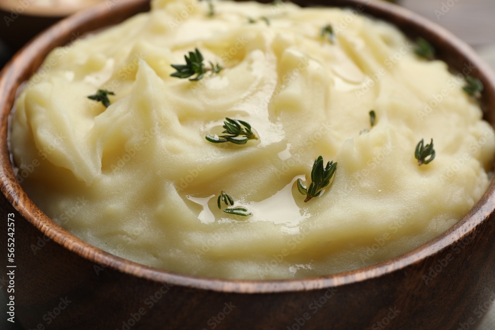 Bowl of delicious mashed potato with thyme, closeup Bowl of delicious mashed potato with thyme, closeup