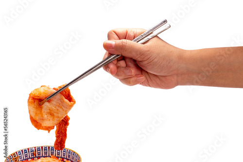 Hand using chopsticks to pick up Kimchi Or fermented vegetables Korean side dish, Fermented vegetables Korean Traditional food on cup isolate on white with clipping path.