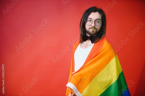 Youth transgender LGBT with Rainbow flag on shoulder isolated color background. gender expression pride and equality concept. © Serhii