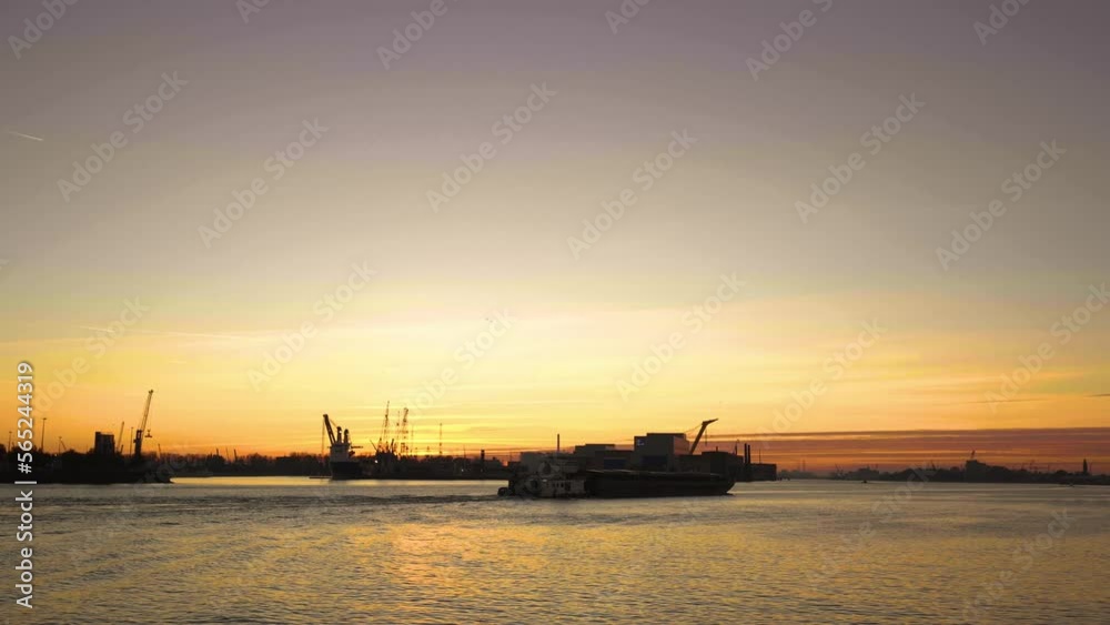 Golden sunset of the harbour of Rotterdam, ship passing by Golden sunset of the harbour of Rotterdam, ship passing by