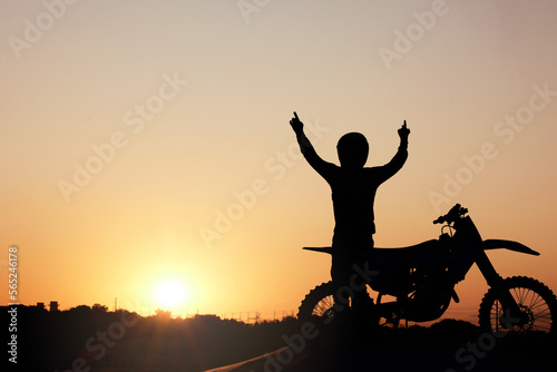 Motorcycle  silhouette and sunset with a sports man outdoor  arms raised in celebration for freedom with mockup. Sky  nature and motorbike with a male rider outside celebrating on a road trip