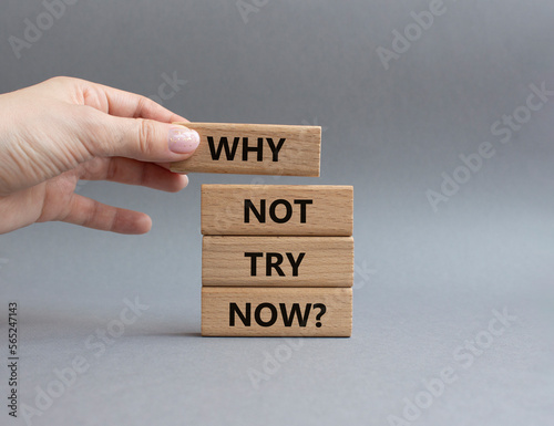 Why not try symbol. Concept words Why not try on wooden blocks. Beautiful grey background. Businessman hand. Business and Why not try concept. Copy space.