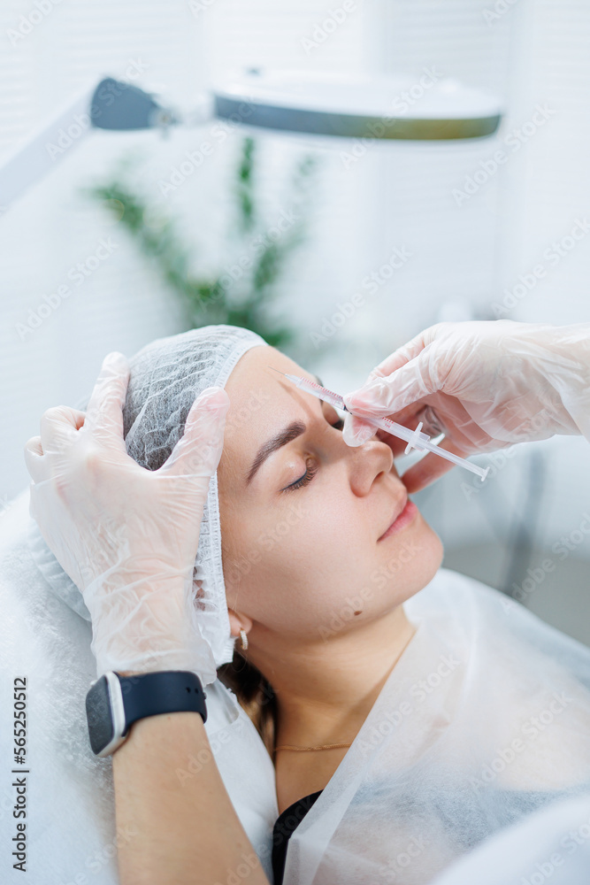 A young woman at an appointment with a beautician, beauty injections for the face. Treatment procedure at a dermatologist