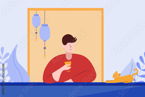 a man is relaxing tea time on the balcony of the house with a cat