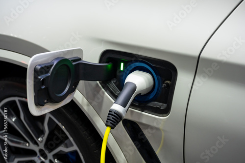 Power cable pump plug in charging power to electric vehicle EV car.