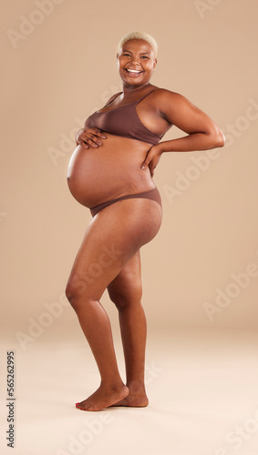 Pregnant, portrait and black woman isolated on studio background for beauty, skincare and happy abdomen health. Underwear, body and african model or person pregnancy for wellness, care and self love