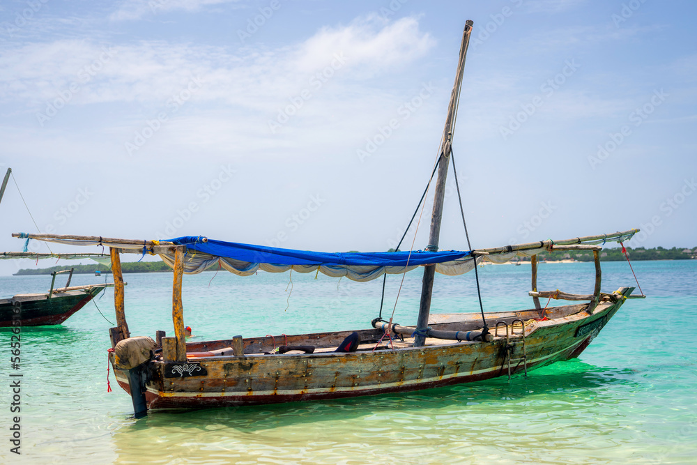 travelling Africa Kenya and Zanzibar seascape with crystal clear turquoise water and traditional sail boat landscape from Diani Beach and Watamu. Kendwa tour with wooden catamaran