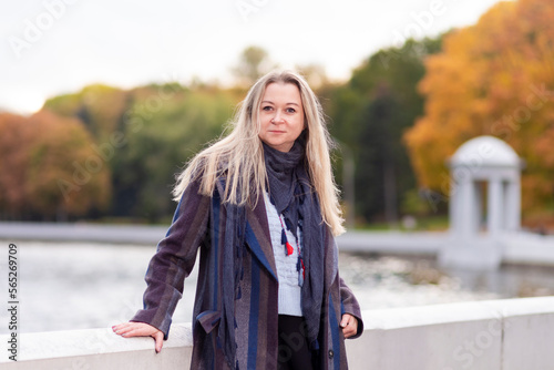 Seasonal and People Ideas. Winsome Caucasian Beautiful Young Woman Walking in Autumn Park