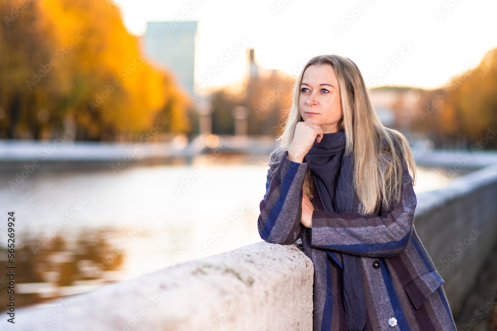 Seasonal and People Ideas. Winsome Caucasian Beautiful Young Woman Walking in Autumn Park Near Bridge  Outdoor