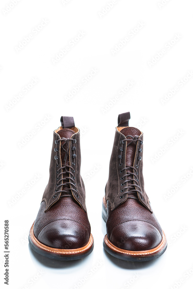 Footwear Ideas. Premium Dark Brown Grain Brogue Derby Boots Made of Calf Leather with Rubber Sole Isolated Over White