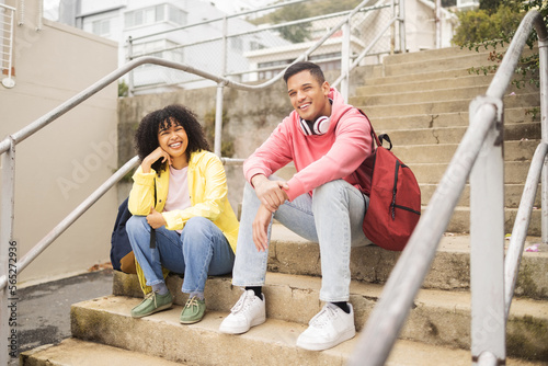 Portrait, stairs and students with a man and black woman sitting outdoor on campus together at university for education. Scholarship, college and school with a male and female pupil seated on steps