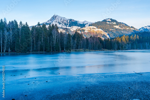 Fototapeta Naklejka Na Ścianę i Meble -  Schwarzsee lake in Kitzbuhel partly covered with ice. Winter in Austria