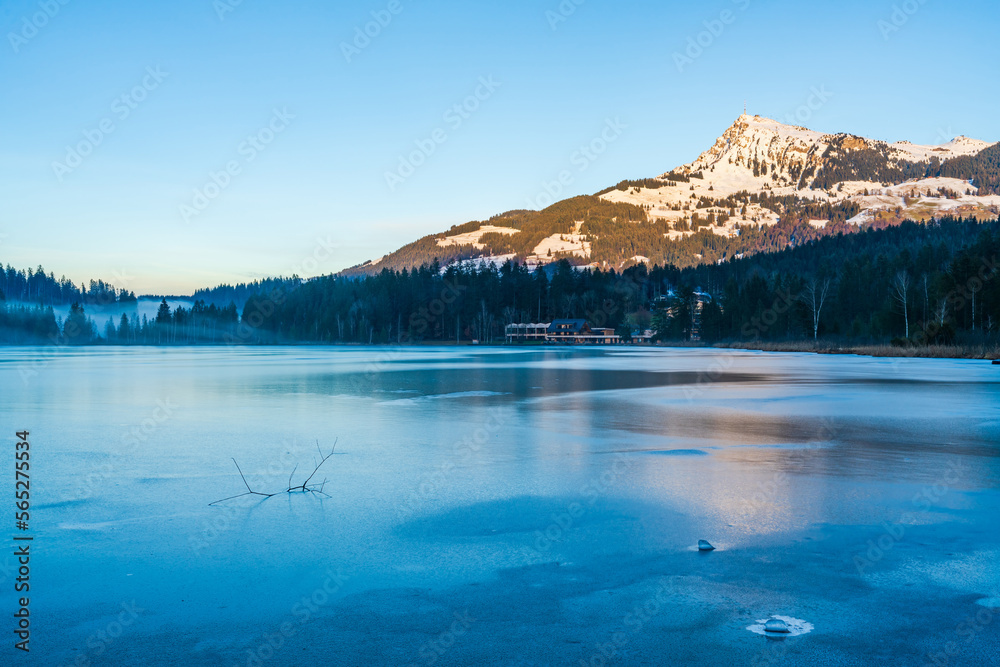 Schwarzsee lake in Kitzbuhel partly covered with ice. Winter in Austria
